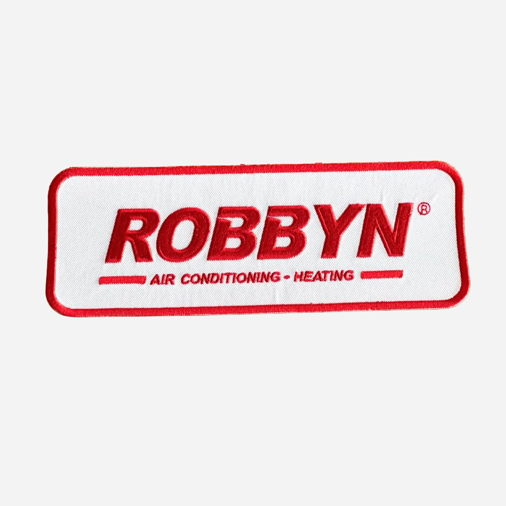 A rectangular patch with a white background and red details, featuring the text 'ROBBYN' along with 'AIR CONDITIONING - HEATING'. The patch is designed to be sewn onto fabric.