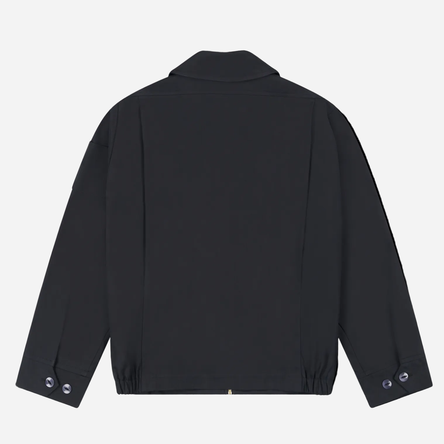 Robbyn unisex black workwear jacket shown from the back, featuring a boxy fit, reinforced seams, adjustable buttoned cuffs, and minimal detailing.