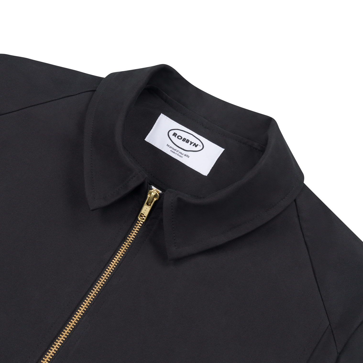 Close up of the Robbyn signature black Mechano jacket, a unisex workwear-inspired silhouette with clean lines and chunky zip.