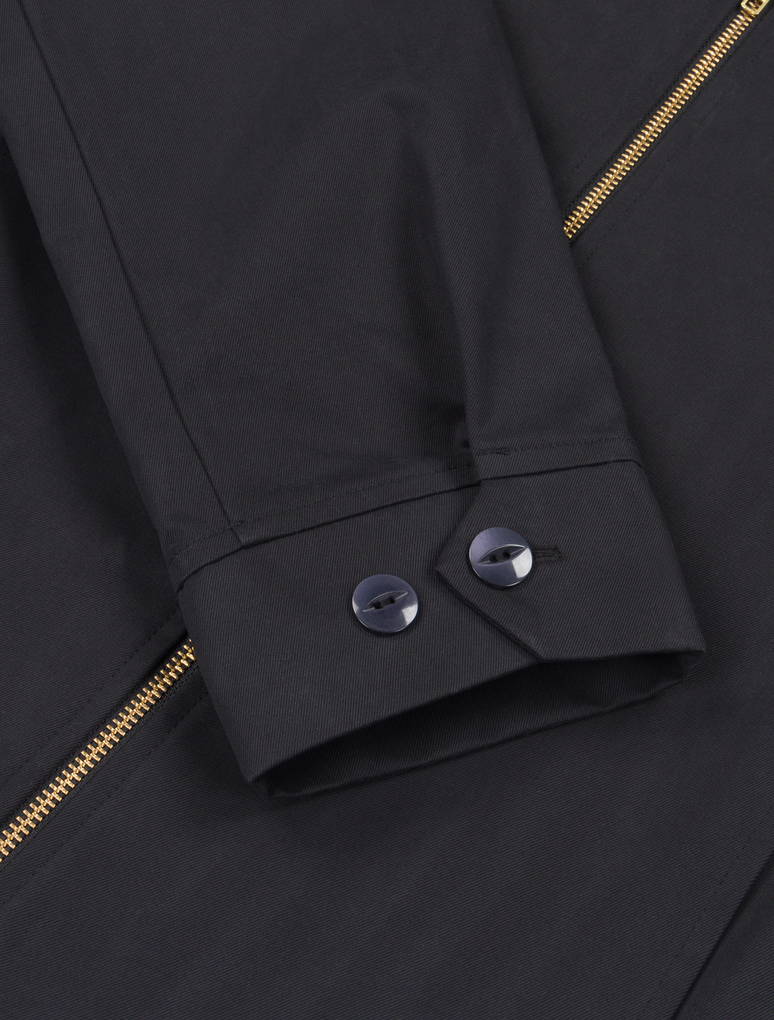 Detail shot of the Robbyn black workwear jacket cuff showing the adjustable buttons closure, reinforced stitching, and durable cotton fabric.