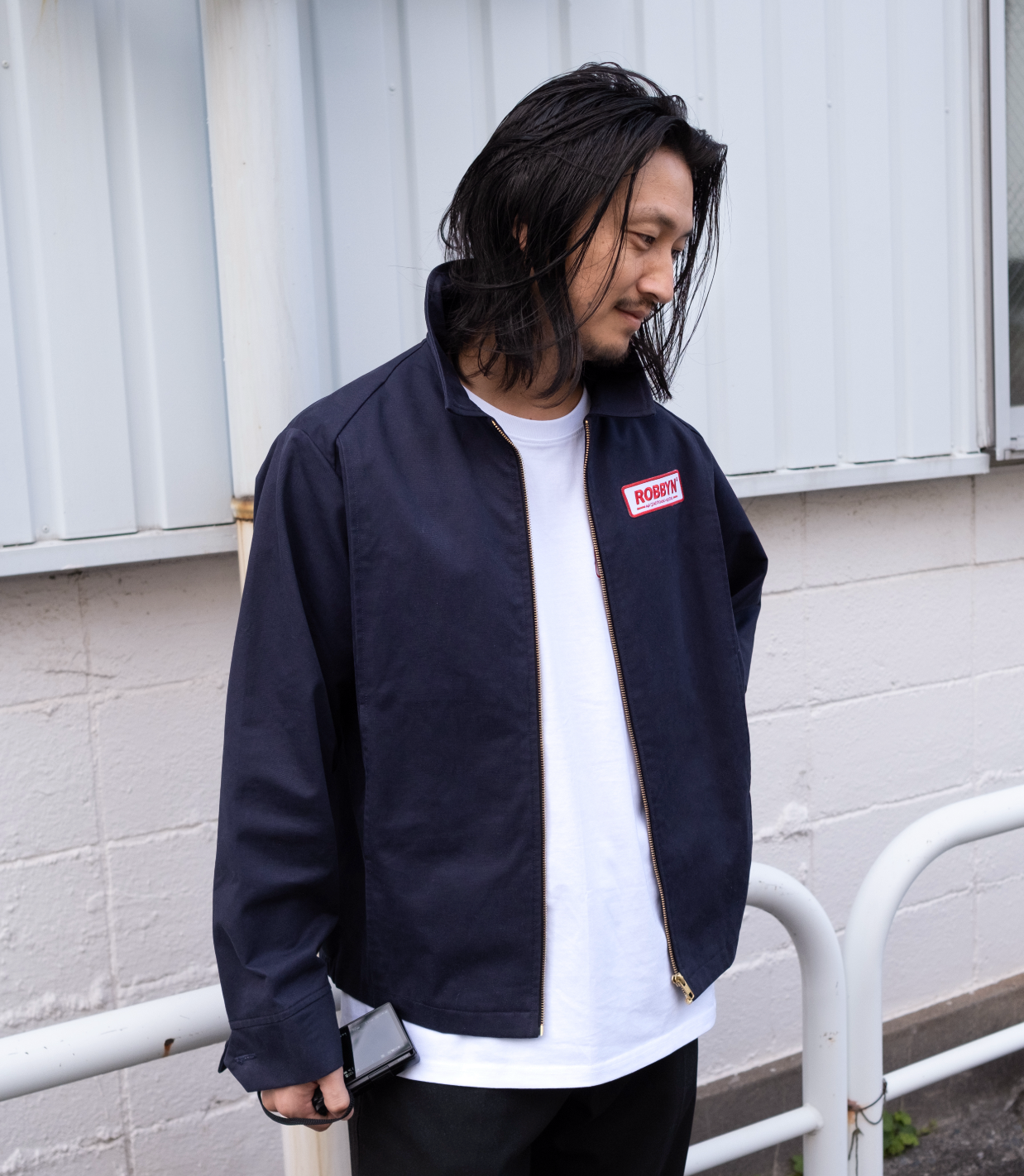 Model wearing the Robbyn navy workwear jacket, showcasing the unisex boxy silhouette and utility-inspired details.