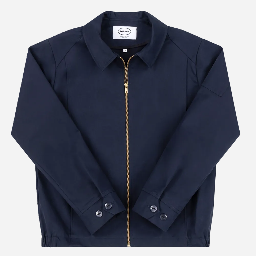 Robbyn unisex navy workwear jacket shown from the front, featuring a boxy fit, reinforced seams, adjustable buttoned cuffs, and minimal detailing.