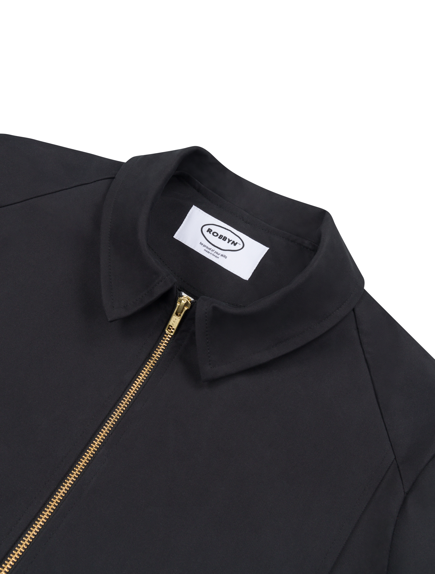 Close up of the Robbyn signature black Mechano jacket, a unisex workwear-inspired silhouette with clean lines and chunky zip.