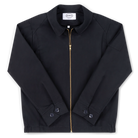 Robbyn unisex black workwear jacket shown from the front, featuring a boxy fit, reinforced seams, adjustable buttoned cuffs, and minimal detailing.