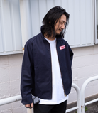 Model wearing the Robbyn navy workwear jacket, showcasing the unisex boxy silhouette and utility-inspired details.