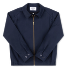 Robbyn unisex navy workwear jacket shown from the front, featuring a boxy fit, reinforced seams, adjustable buttoned cuffs, and minimal detailing.