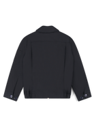 Robbyn female black workwear jacket shown from the back, featuring a boxy fit, reinforced seams, adjustable buttoned cuffs, and minimal detailing.